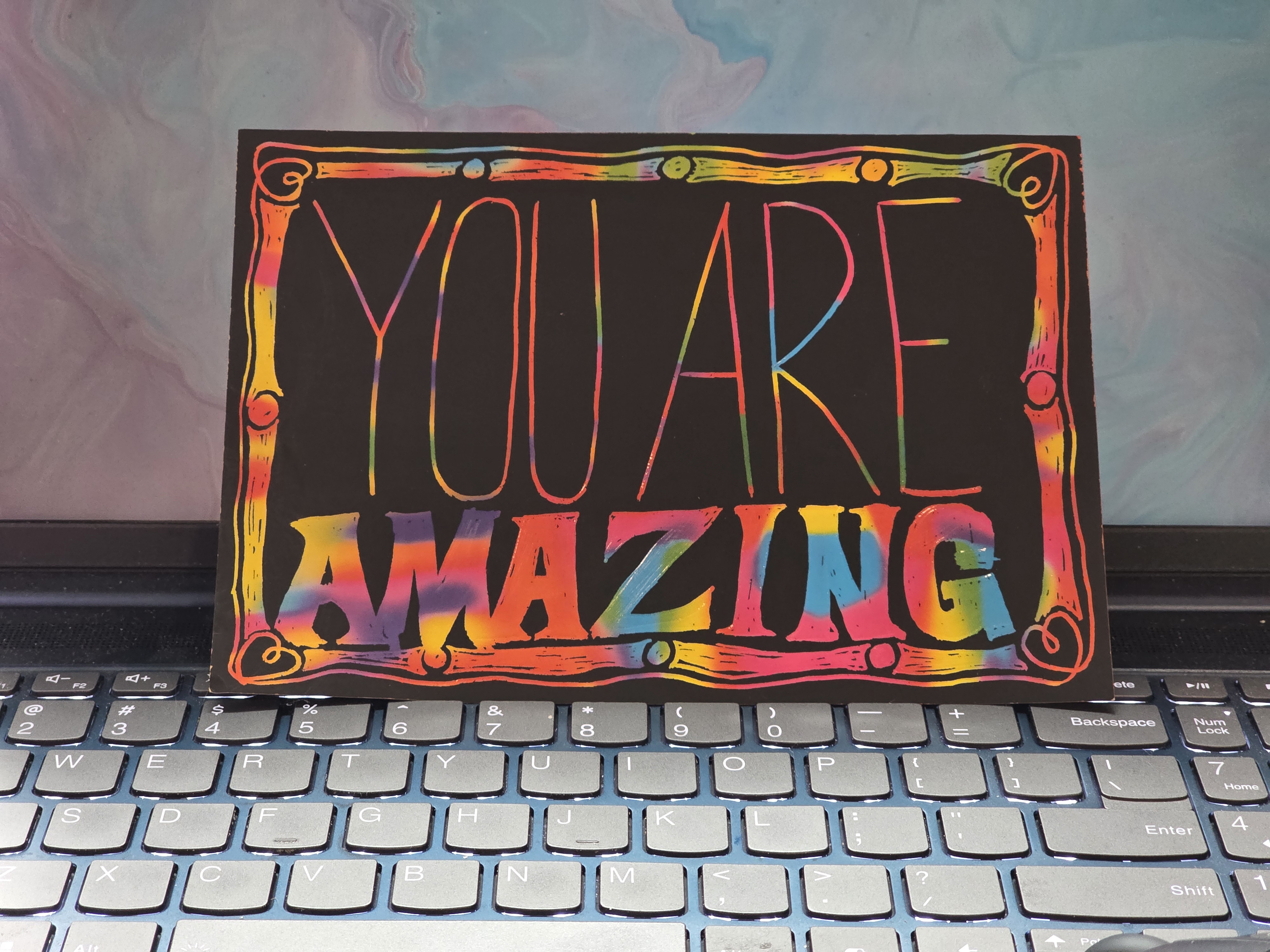 scratch art featuring a decorative border with the words "YOU ARE AMAZING" written on it.
