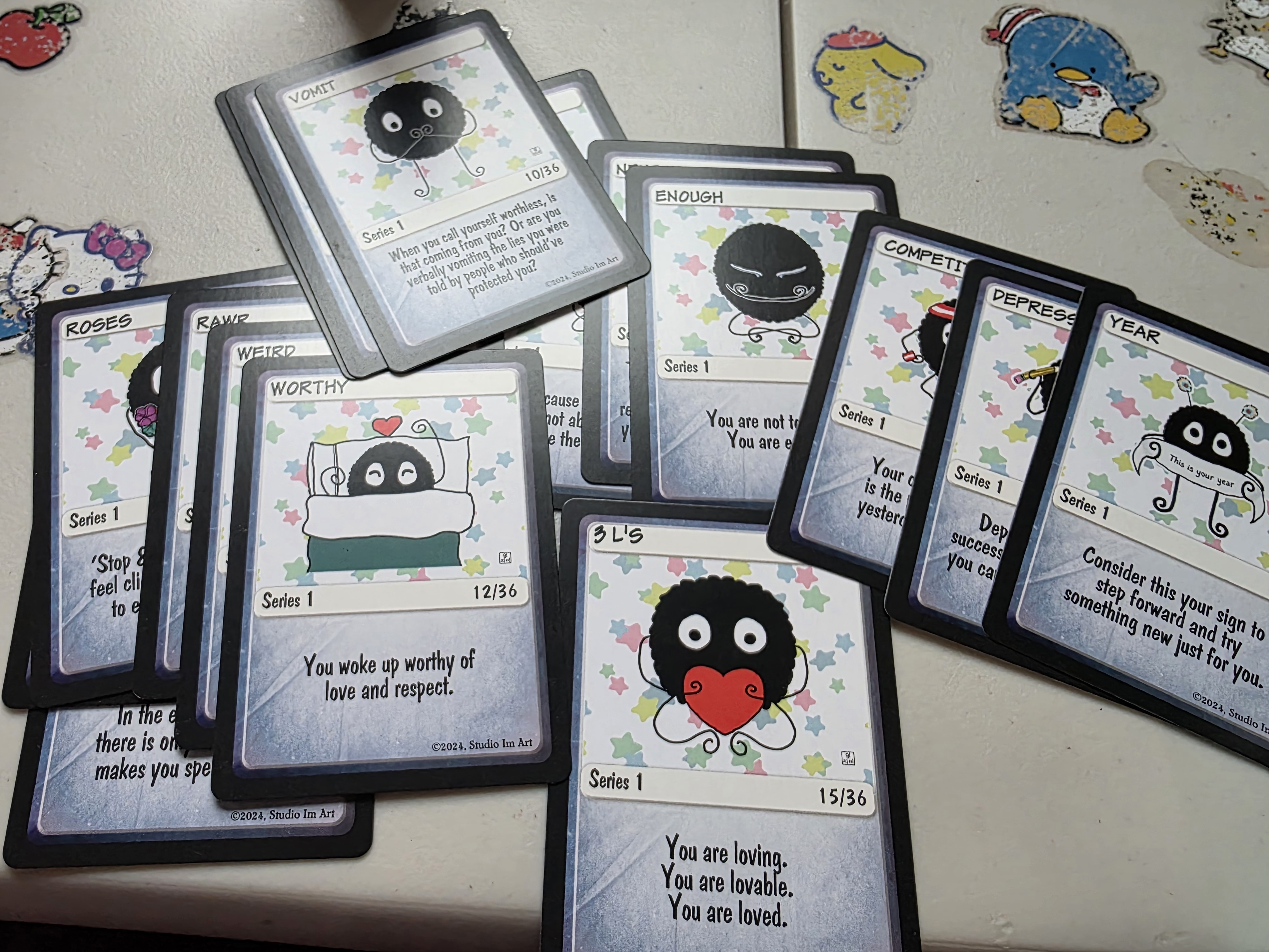 A variety of trading cards featuring custom art created by CL Huth, known as Studio IM Art on social media.