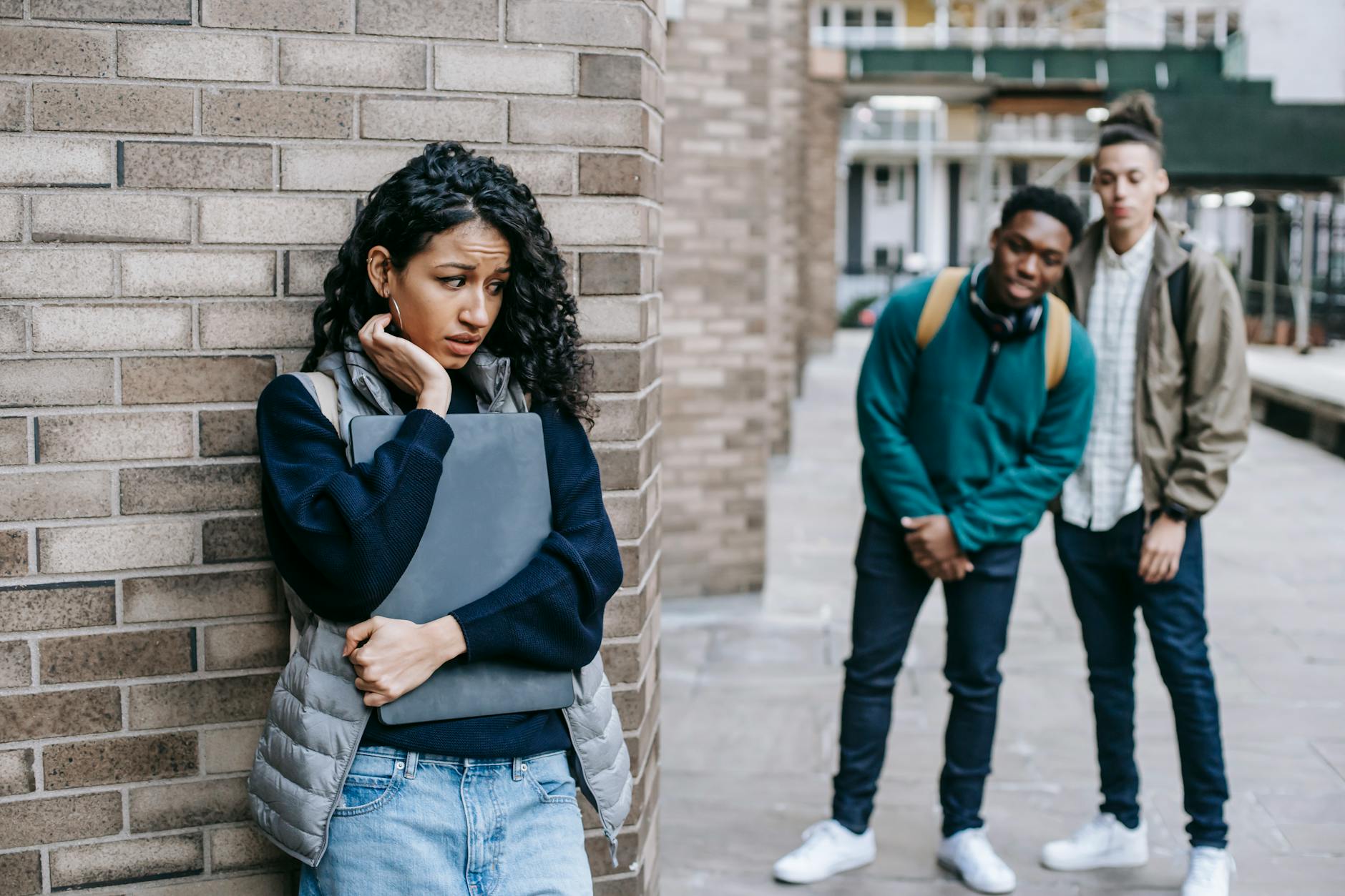 nervous woman around the corner from two people who appear to wish to socialize