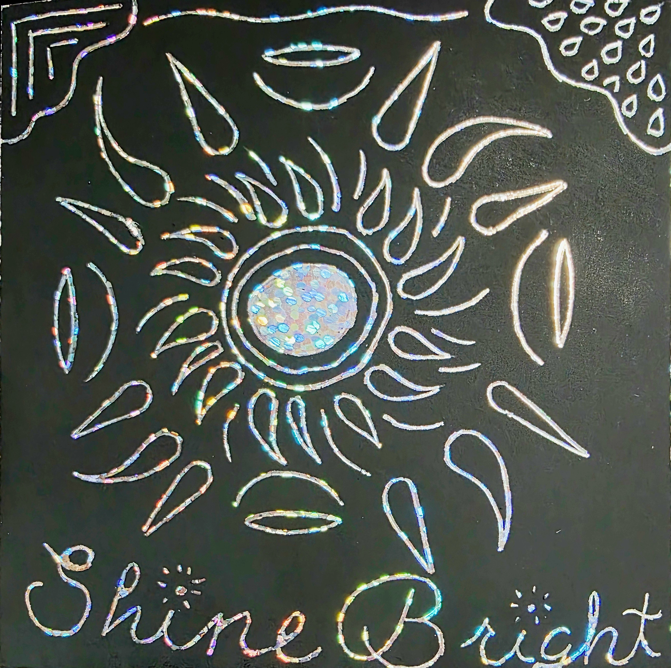 scratch art line art on holographic paper with the words "Shine Bright"